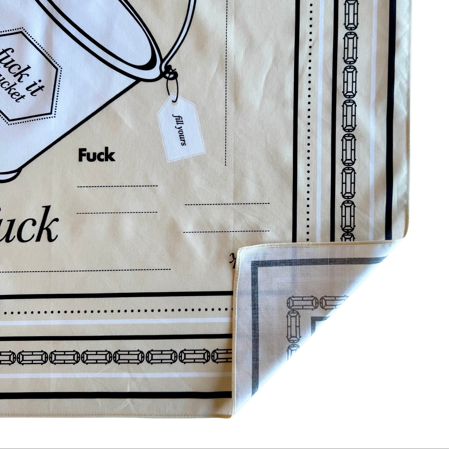 Beige "Fuck It Bucket" cotton bandana with corner folded up to reveal back/ unprinted side of bandana.