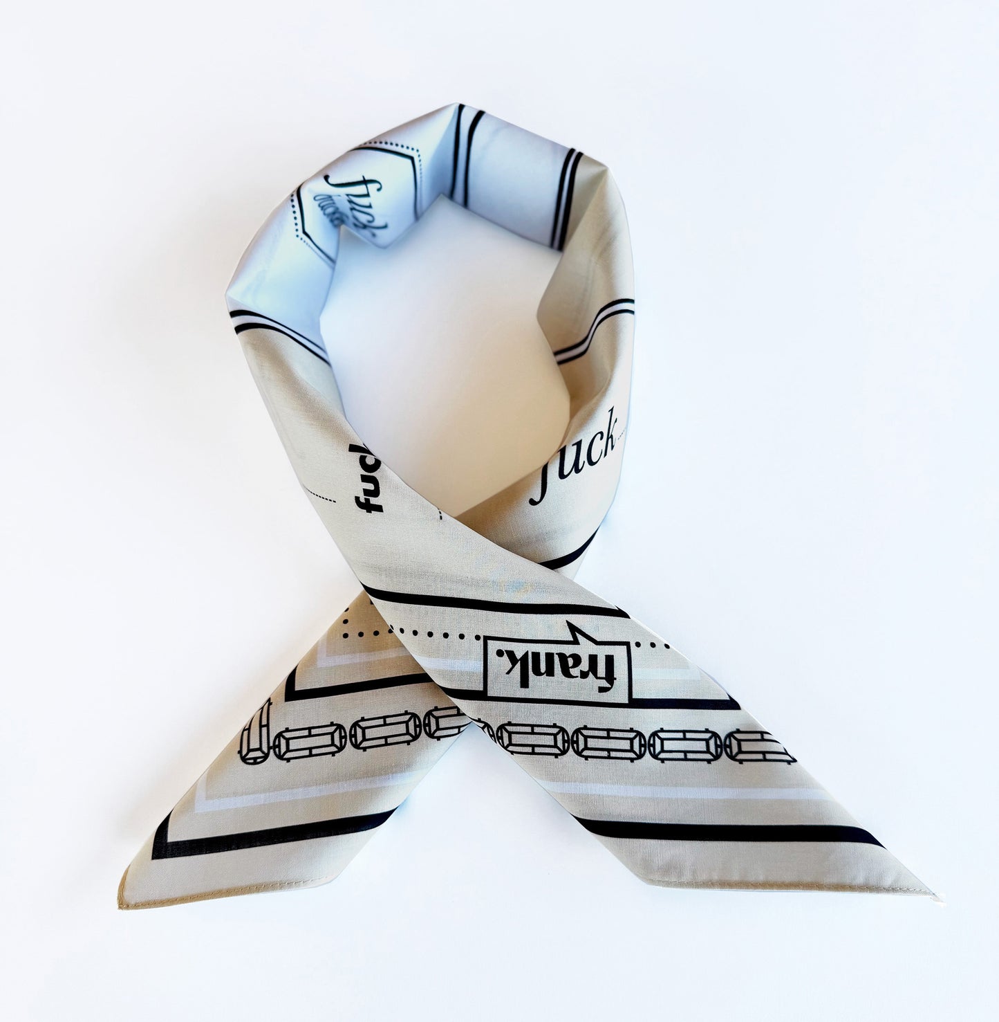 Beige cotton bandana folded as one would wear it around their neck.