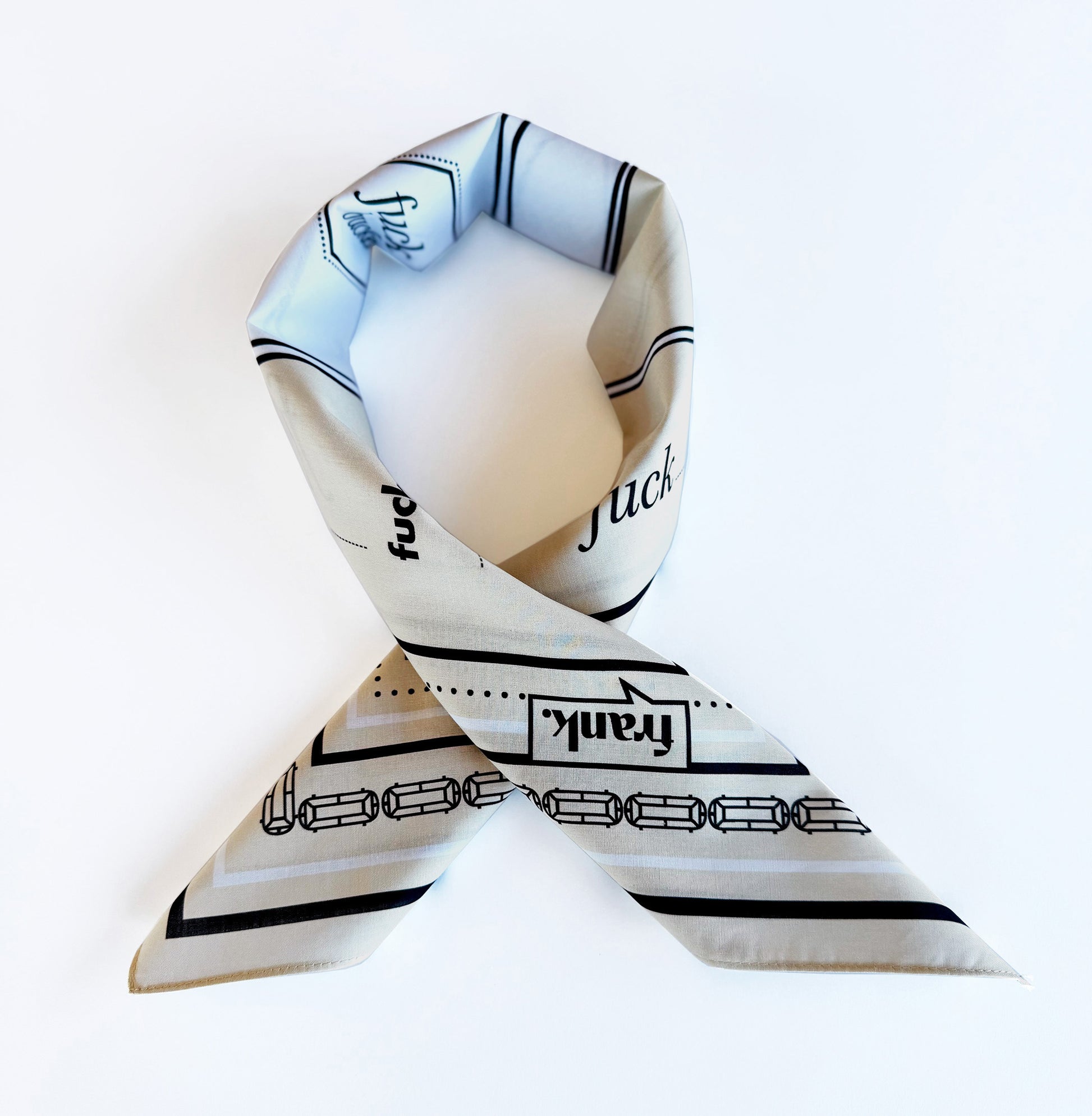 Beige cotton bandana folded as one would wear it around their neck.