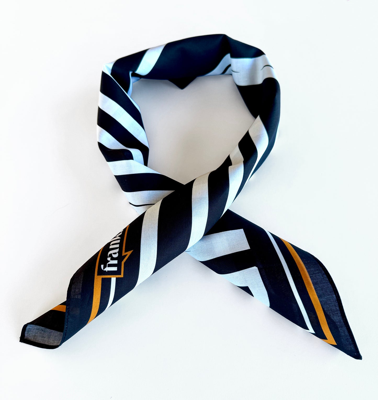 Black and white striped bandanawith gold accents on a white background