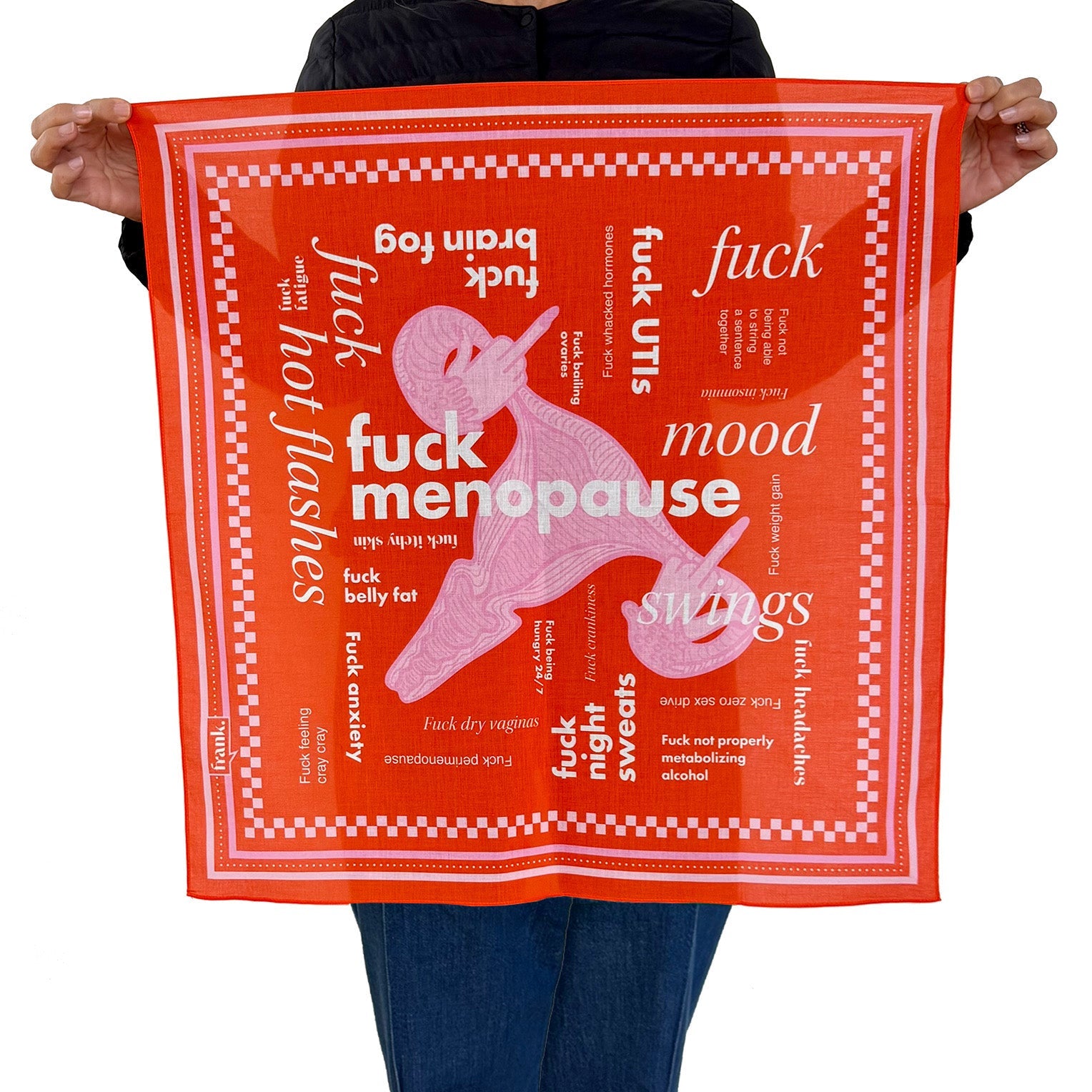 Person holding a deep orange bandana with white text and graphics on a white background. Themes and text are about menopause symptoms including 'Fuck Menopause'. 