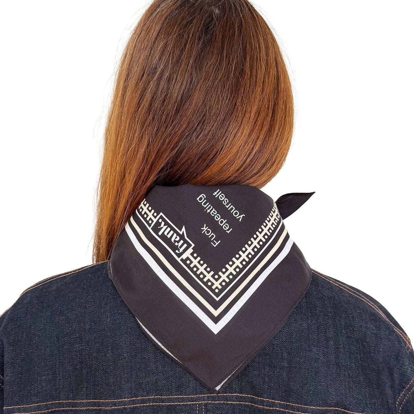 Back view of a person wearing a black and white bandana around their neck  against a white background