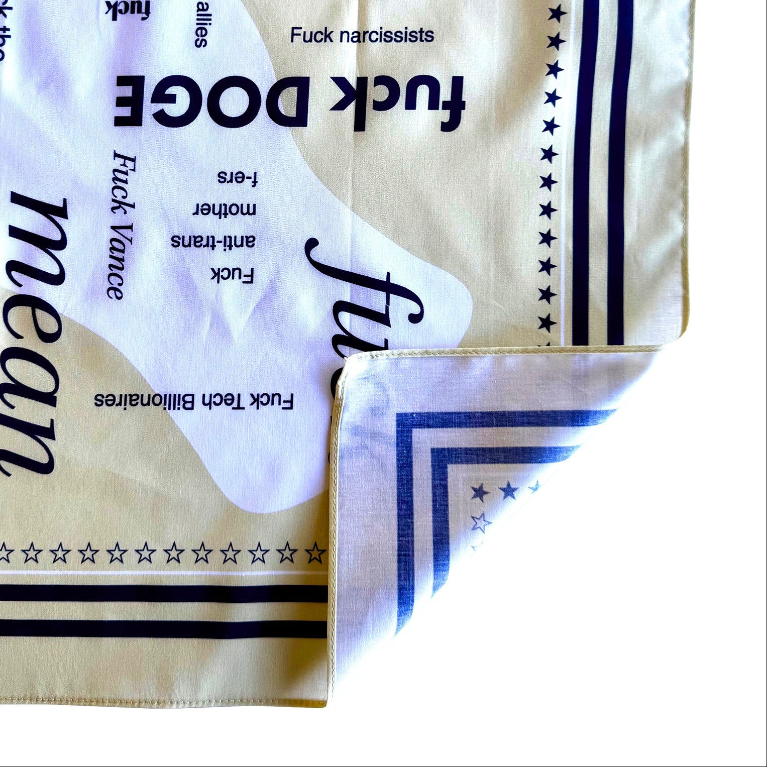 Close up of 100% cotton bandana with corner turned up to show backside/underside of bandana - showing one-sided printing.