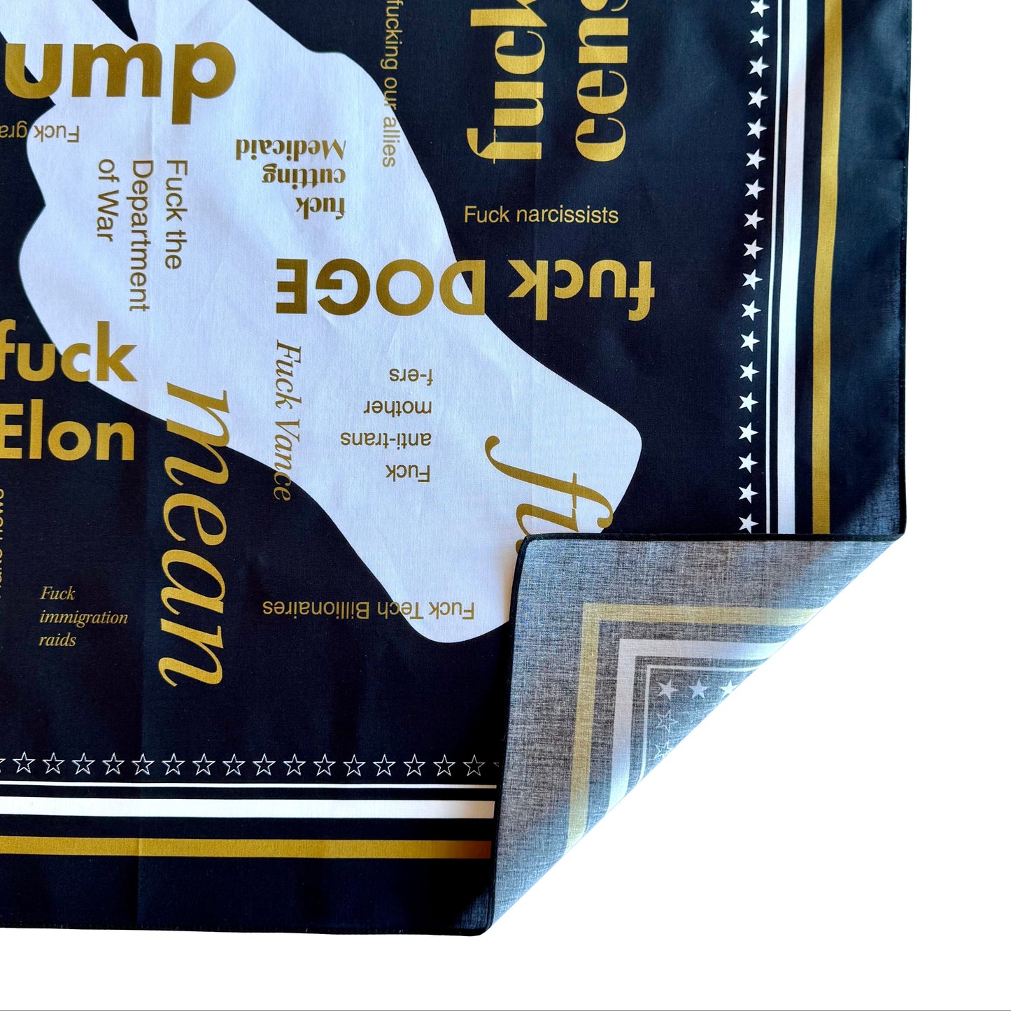 Close up of black and gold political 100% cotton bandana with corner turned up to show underside / backside of bandana, showing one side printing of product. 