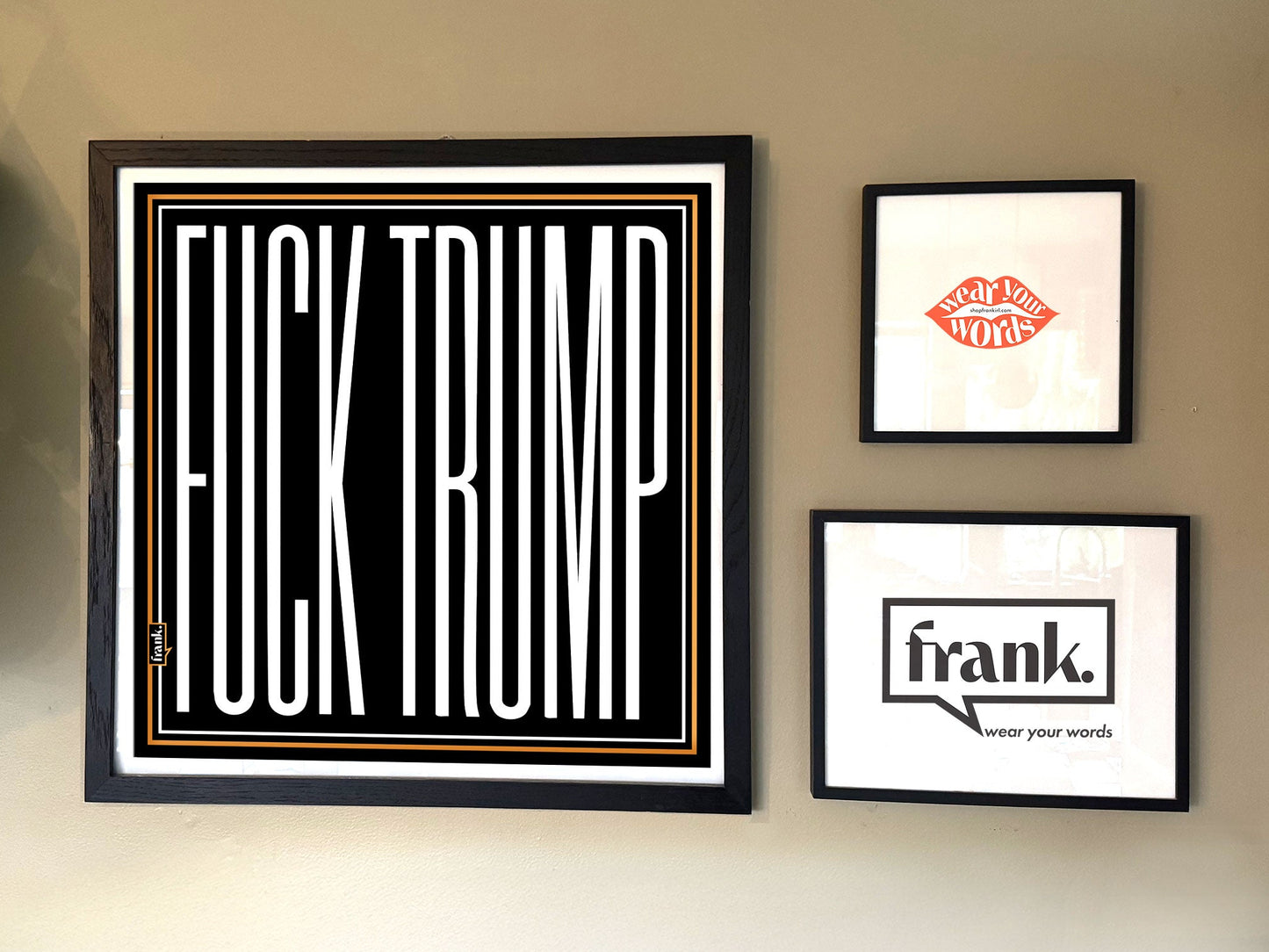 Framed Trump bandana on a wall with other prints.