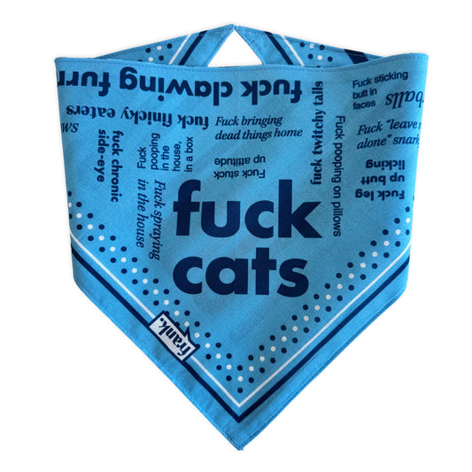 A light blue pet bandana with bold dark blue text reading 'fuck cats' and smaller text including 'fuck bringing dead things home', and 'fuck twitchy tails'. The bandana has a pointed triangular shape, dark blue border lines, white polka dots, and a small white label near the bottom edge with the brand name 'frank'.