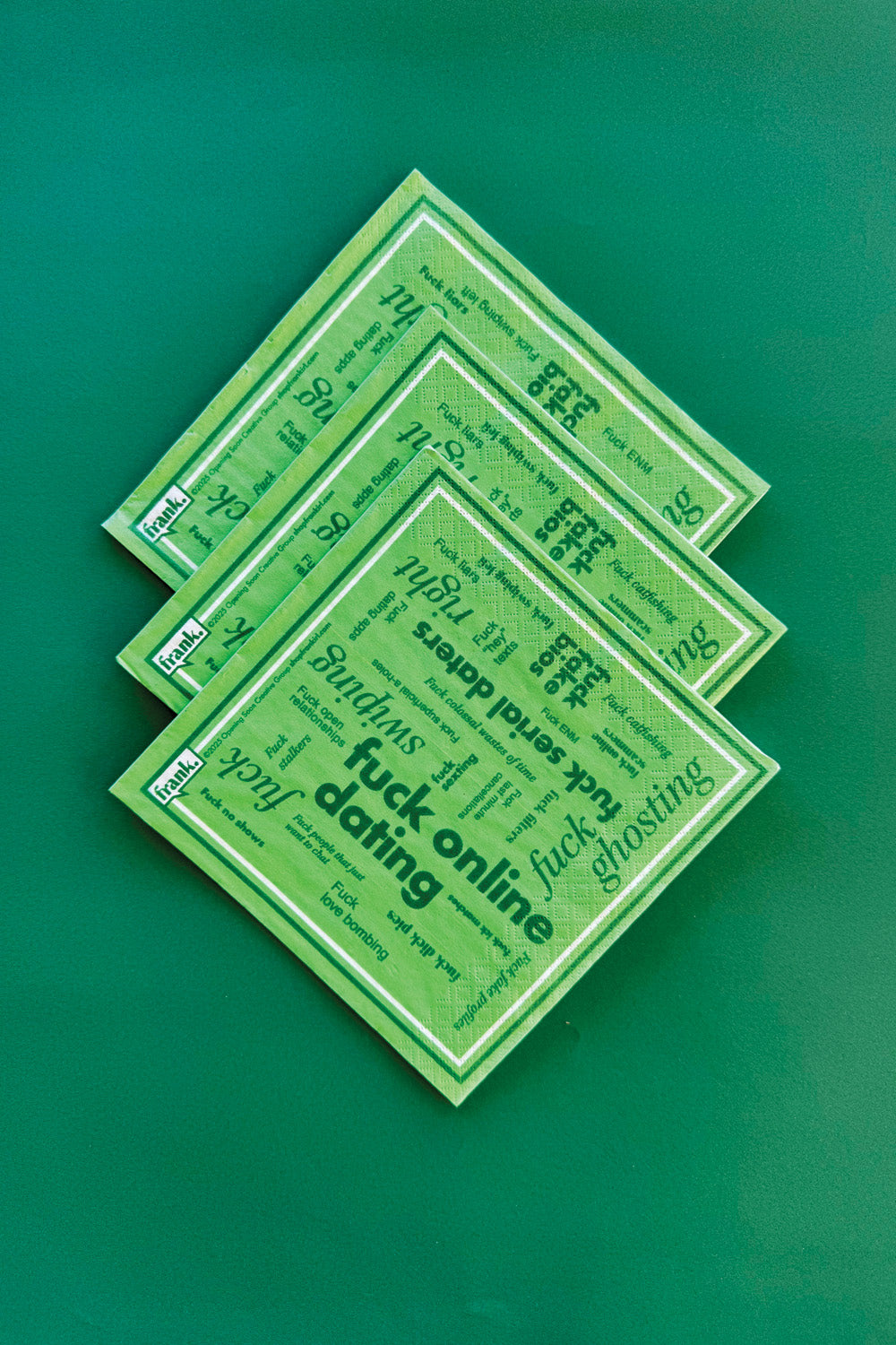 Fuck Online Dating green napkins fanned out on a green background
